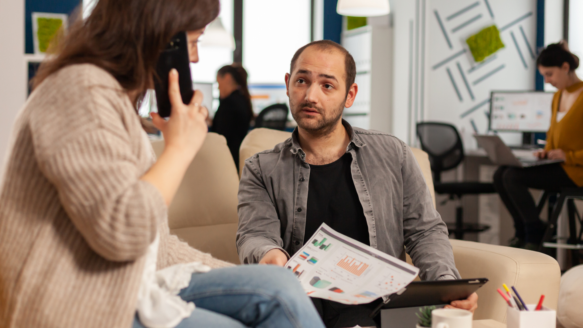 Consultor da Fenicio apresentando relatório de métricas e gráficos de performance para cliente durante sessão de treinamento estratégico.